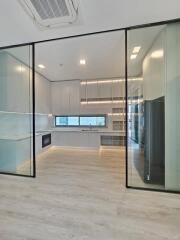 Modern kitchen with glass partitions and high-end appliances