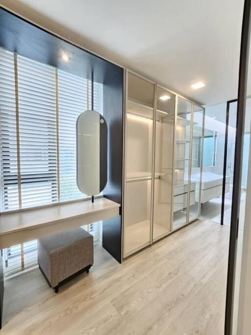 Bedroom with walk-in closet and vanity area