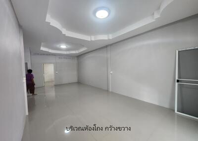 empty room with white walls, tiled floor, and ceiling lights