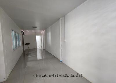 Narrow corridor with white walls and tiled floor