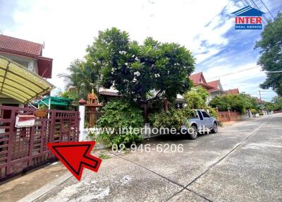 Exterior view of a residential property with a gate and garden