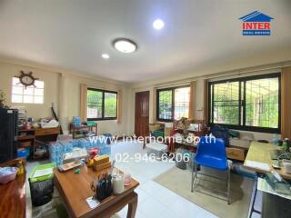 interior of a living area with multiple windows and furniture