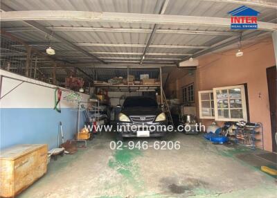 Garage with a vehicle and storage shelves