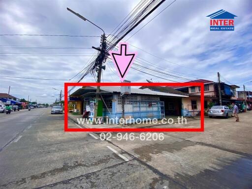 Street view of a commercial building with sign and contact details