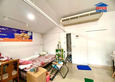 Bedroom with single bed, wall-mounted air conditioner, table, and chair