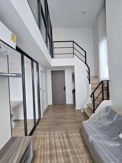 Modern duplex living room with wooden flooring and loft space