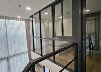 Modern hallway with glass windows and metal railings