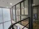 Modern hallway with glass windows and metal railings