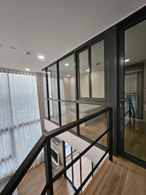 Modern hallway with glass windows and metal railings