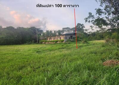 Vacant land with distant view of building and trees