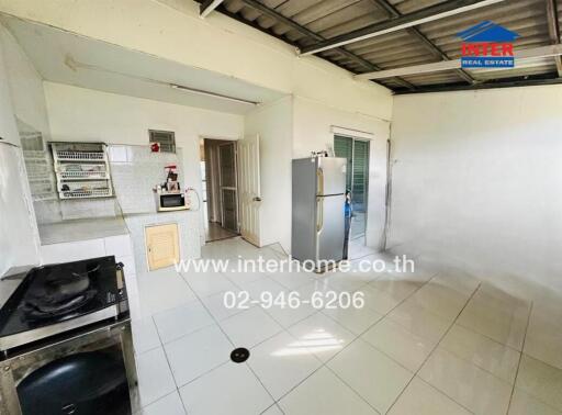 Modern kitchen with appliances and white tiled floors