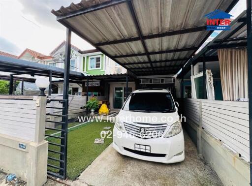 Exterior view of residential property with carport and front yard