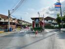 Gated residential community entrance with surrounding houses in the background