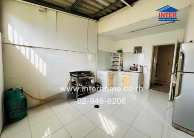 Spacious kitchen with basic appliances and natural light