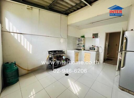 Spacious kitchen with basic appliances and natural light