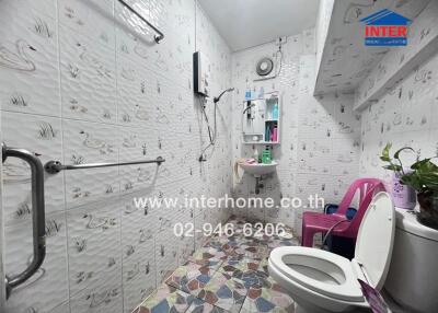 Bathroom with patterned tiles, sink, and toilet