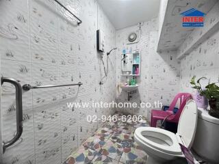 Bathroom with patterned tiles, sink, and toilet