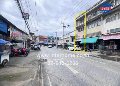 Street view with commercial buildings and vehicles