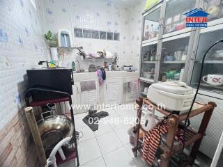 Small kitchen with various appliances and storage