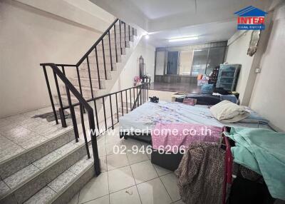 Bedroom with bed, stairs, and window