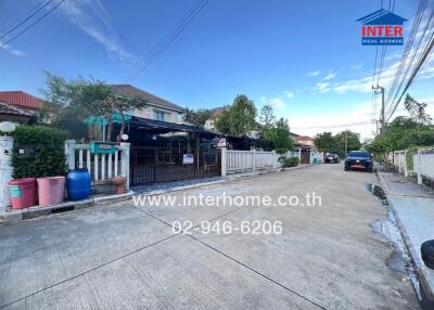 Street view of residential houses with visible interhome real estate branding