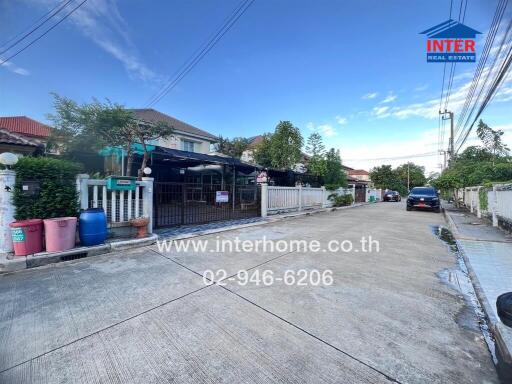 Street view of residential houses with visible interhome real estate branding