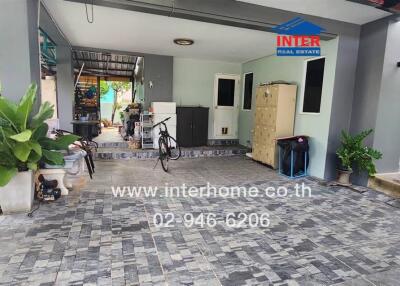 Modern home entrance with tiled flooring and greenery