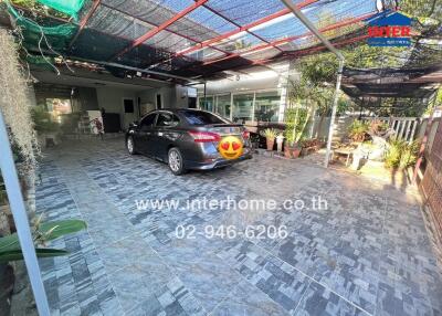 Spacious garage with tiled flooring and car parked