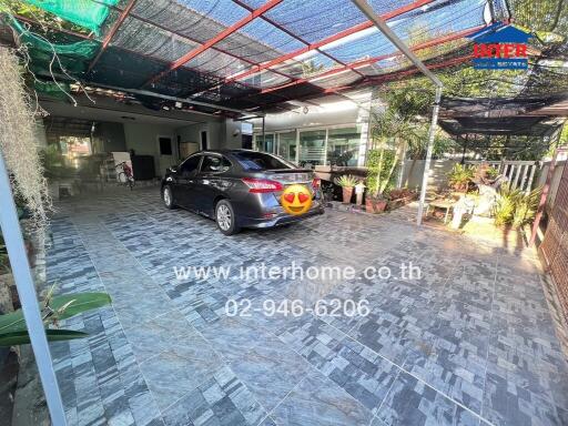 Spacious garage with tiled flooring and car parked