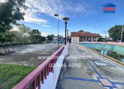 Outdoor recreation area with a pool and basketball court