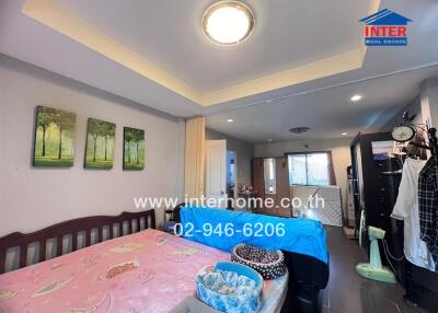Bedroom with bed, ceiling light, and decorations