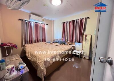 Bedroom with bed, curtains, and air conditioning unit
