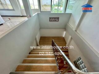 Staircase leading to the upper floor with a steel railing