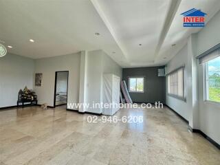 spacious living room with large windows and tiled floor