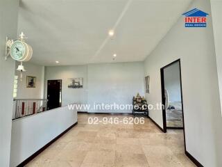 Spacious living area with tiled flooring and modern decor