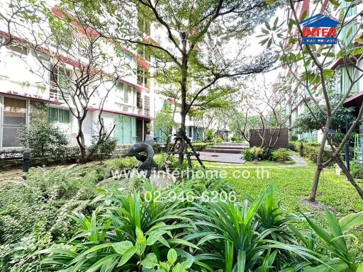 Green courtyard with plants and trees in an apartment complex
