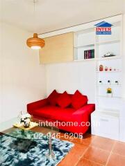 Cozy living room with red sofa and built-in shelving