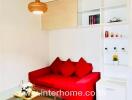 Cozy living room with red sofa and built-in shelving