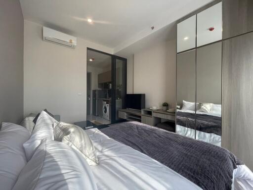 Modern bedroom with glass door leading to laundry area