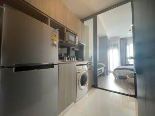 Modern kitchen with adjacent bedroom view