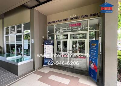 Main entrance of the real estate office with glass doors and signage.