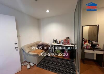 Cozy bedroom with seating area and mirrored wardrobe