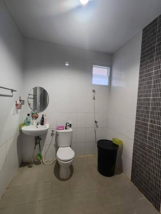 A modern bathroom with a sink, toilet, and shower area