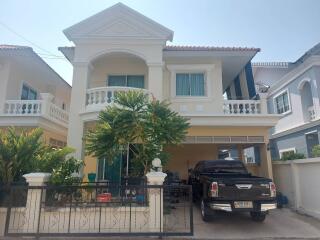 Two-story house with balcony and garage