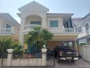 Two-story house with balcony and garage