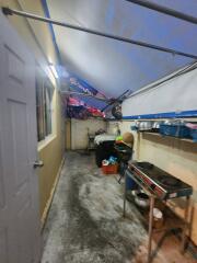 Narrow kitchen with stove and storage shelves