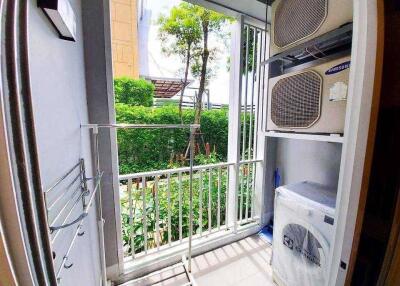 Laundry area with washing machine and air conditioning units