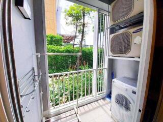 Laundry area with washing machine and air conditioning units