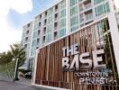 Modern condominium building exterior with 'The Base Downtown Phuket' signage