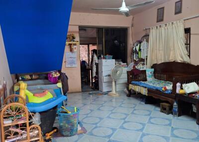Cluttered living space with furniture and children